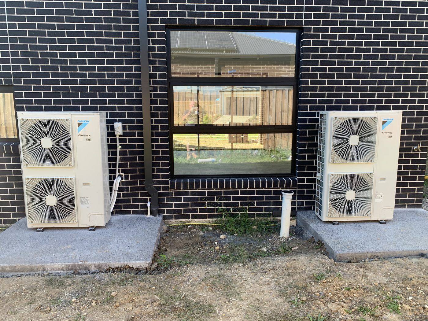 Two Daikin split system outdoor units installed on concrete pads by A-Temp Installations